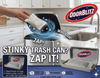 Advertisement for OdorBlitz product showing a trash can with a hand using a pouch, set against a kitchen background.